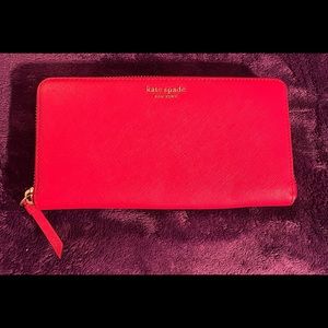 Brand new, never used Red Kate Spade of New York wallet with tons of space!